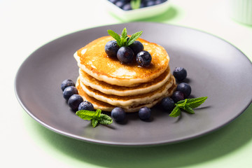 Stack of home made pancakes served with fresh berries and maple syrup. Simple and delicious breakfast