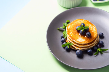 Stack of home made pancakes served with fresh berries and maple syrup. Simple and delicious breakfast