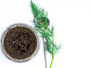 Vintage silver spoon with black sturgeon caviar on white background. Top view, flat lay
