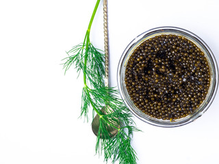 Vintage silver spoon with black sturgeon caviar on white background. Top view, flat lay
