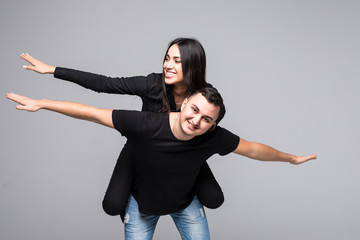 Young couple with hands arms like wings piggy-back ride walk highway adventures wear casual clothes...