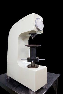 Rockwell hardness tester on a black background. Machine Building Plant.