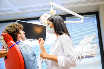 A female Dentist preparing to examine a Patient