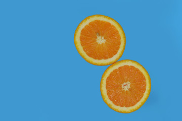 two half ripe orange fruit 