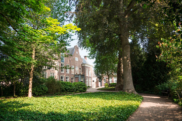 Fototapeta na wymiar building and trees in shadow, public park Stadhuistuin, Tiel, The Netherlands