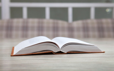 Book on bright table on blurred background