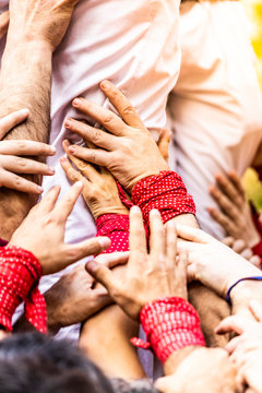 Close-up of the joining hands building a "castell"