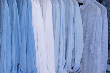 background of shirts blue and white hanging on a hanger