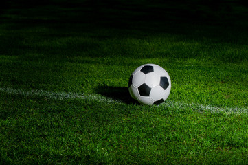 Fototapeta na wymiar Black and white soccer ball in the field