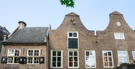 Fototapeta na wymiar row gables of building with shutters in public park Stadhuistuin, Tiel, The Netherlands
