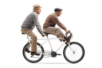 Two elderly men riding a tandem bicycle with legs up