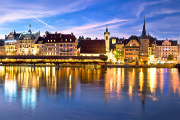 Luzern Kapelbrucke and riverfront architecture famous Swiss landmarks evening view