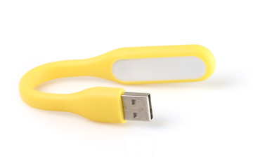 USB yellow plastic LED light lamp, isolated on a white background. Closeup.