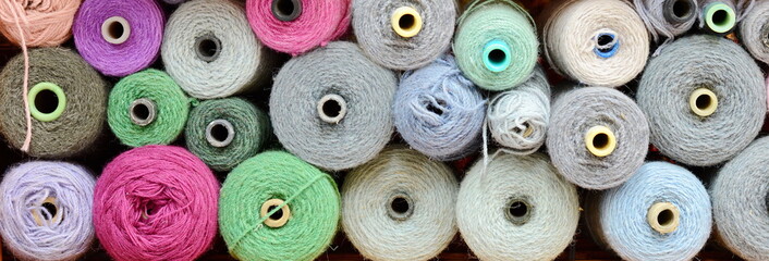 Color yarn for knitting, knitting wool balls . Beautiful yarn knitting background. Close up of multi colored kitting yarn.