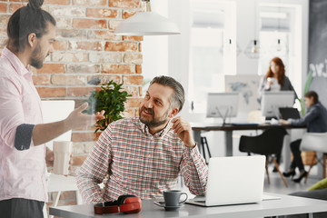 Co-workers talking about project while working in international company