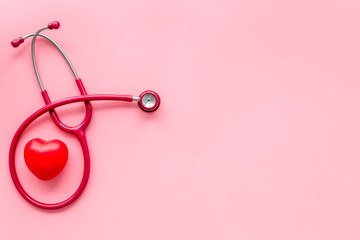 Stethoscope and heart for family doctor set to cure of cardiac disease on pink background top view space for text