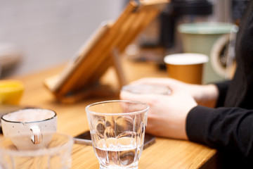 coffee and hands close-up in a coffee shop on a wooden table