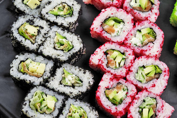 Sushi set on a black dish.Close-up.