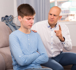Man scolding his teenage son