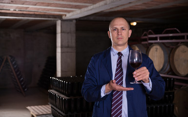 Winemaker offering red wine for tasting