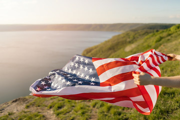 Young woman holding USA flag for freedom concept. American flag.
