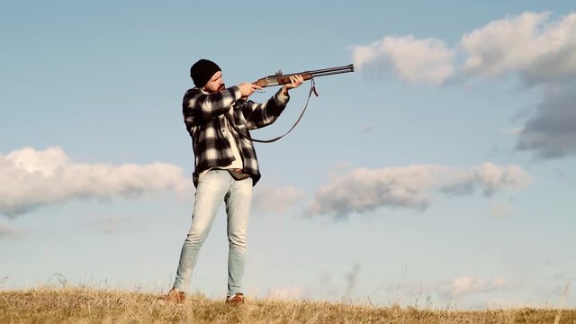 Autumn hunting season. Man with gun. Calibers of hunting rifles. American hunting rifles. Sporting clay and skeet shooting.