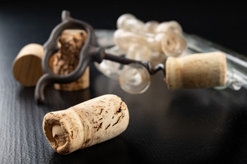 Fermentation tube and corkscrew on a black table. Accessories needed to prepare homemade wine.