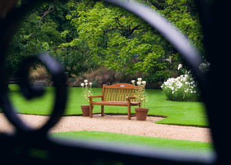 Close-up of a bench through a grate