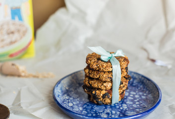 asty homemadeoats cookies decorated of blue satin ribbon on the creative bright blue plate