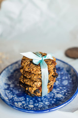 asty homemadeoats cookies decorated of blue satin ribbon on the creative bright blue plate
