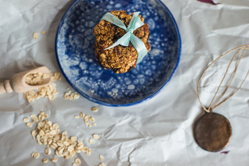 asty homemadeoats cookies decorated of blue satin ribbon on the creative bright blue plate