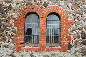 Vintage old windows on a stone wall