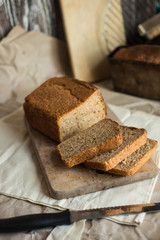 Fototapeta na wymiar fresh homemade sourdough wheat form bread served on the rustic background