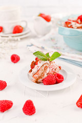 Traditional Italian cake with mascarpone cheese and berries. Tiramisu with raspberry berries and espresso coffee. Homemade breakfast on a white background. Copy space.