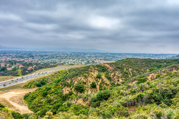 Fototapeta na wymiar city below forest in southern california on cloudy spring day