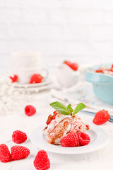 Traditional Italian cake with mascarpone cheese and berries. Tiramisu with raspberry berries and espresso coffee. Homemade breakfast on a white background. Copy space.