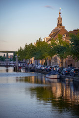 Obraz premium Reflection of Traditional Dutch facades, church tower and canal street