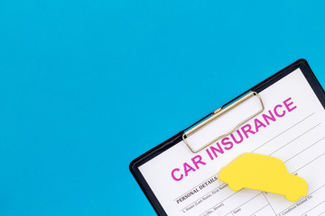 buying new auto concept with insurance form, glasses and car toy on blue background top view copy space