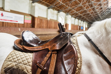 Leather horse saddle closeup. For the rider