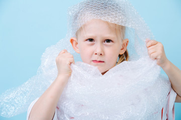 Little boy is dressed in bubbled wrap in protest of waste crisis