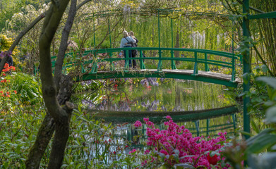 Giverny, France - 05 07 2019: The gardens of Claude Monet in Giverny. The nympheas and the bridge - obrazy, fototapety, plakaty