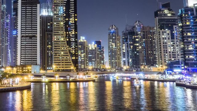 Night timelapse in Dubai Marina District famous for supermodern skyscrapers and nightlife