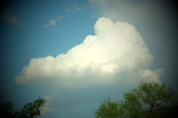 Blue sky on a Sunny day with big white clouds. The sky before the rain. Natural background.