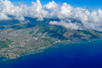 Honolulu on Oahu aerial view above clouds