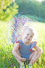 toddler girl in field dressed in red white and blue 