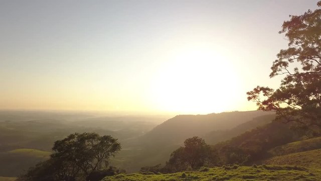 Footage aerial of sunrise in mountains and yellow sun