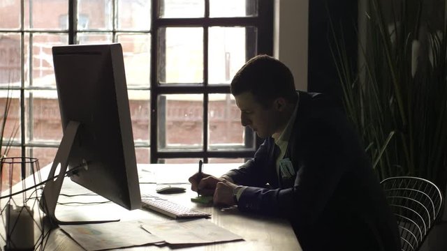 silhouette businessman working in the office on the background of the window