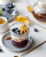 Concept of tasty granola with yogurt and blueberry