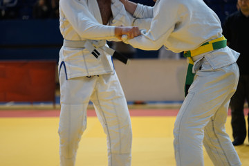 Fototapeta premium Brazilian jiujitsu fighters in a fight stand up wrestling at the tournament BJJ