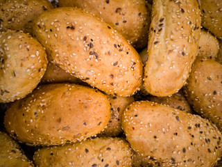 buns with poppy seeds piled on the table. fresh bakery.
